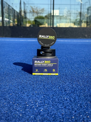 Rally360 padel phone mount with retail packaging box on court surface
